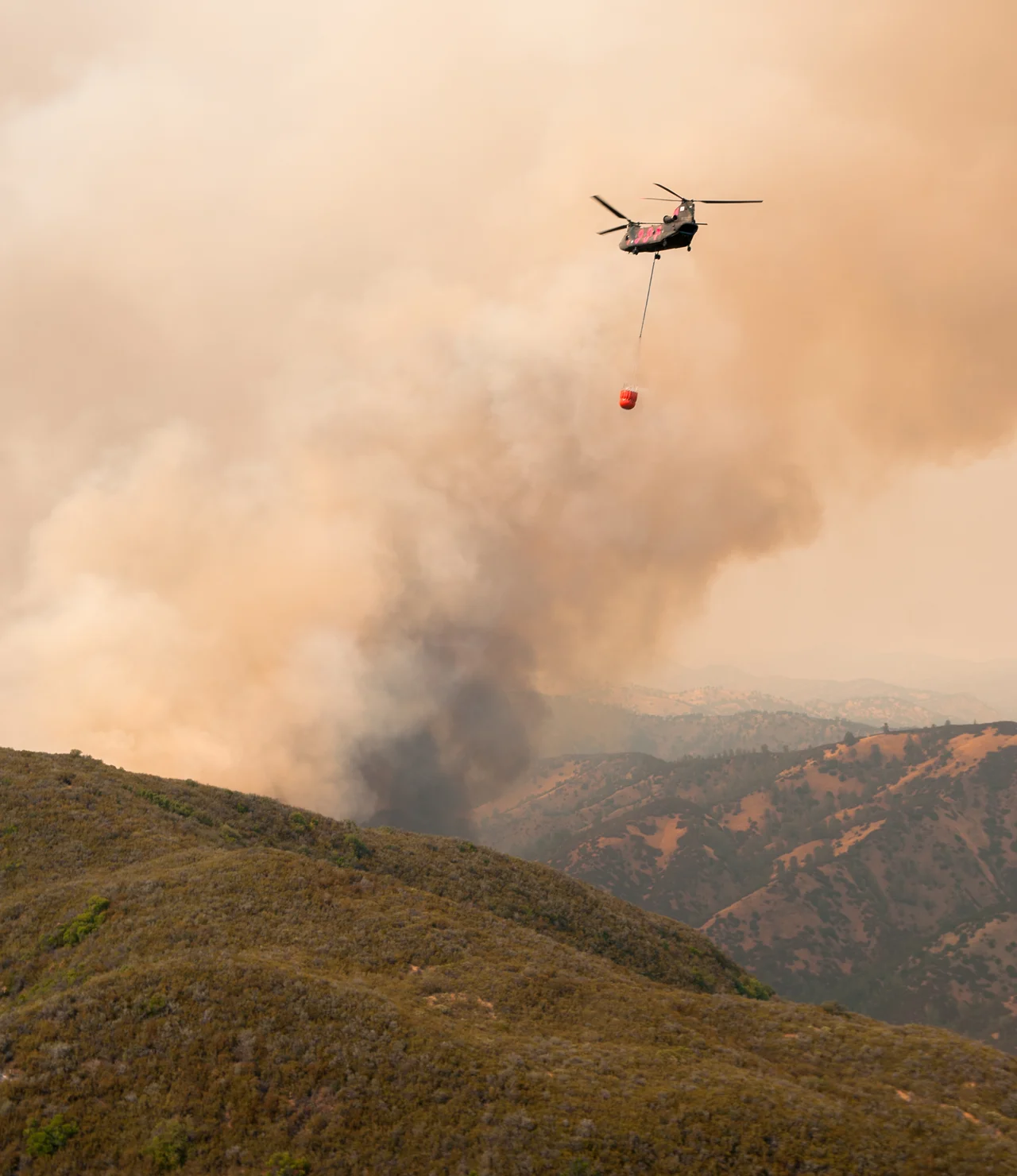 A CH-47 Chinook from the California National Guard's 1-126th Aviation Regiment helicopter prepares to approach for a water drop during the Rocky Fire near Clearlake, Calif., Aug. 1. (U.S. Army National Guard photo/ Sgt. Jason Beal/ released)