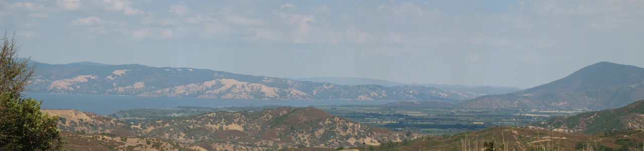 Clear Lake, from Route 175 in Lake County, northern California.
The Clear Lake region was the former homeland of the Miwok, Pomo, and Wappo indigenous peoples, with their sacred and archeological sites.
Photo by Kit Conn.