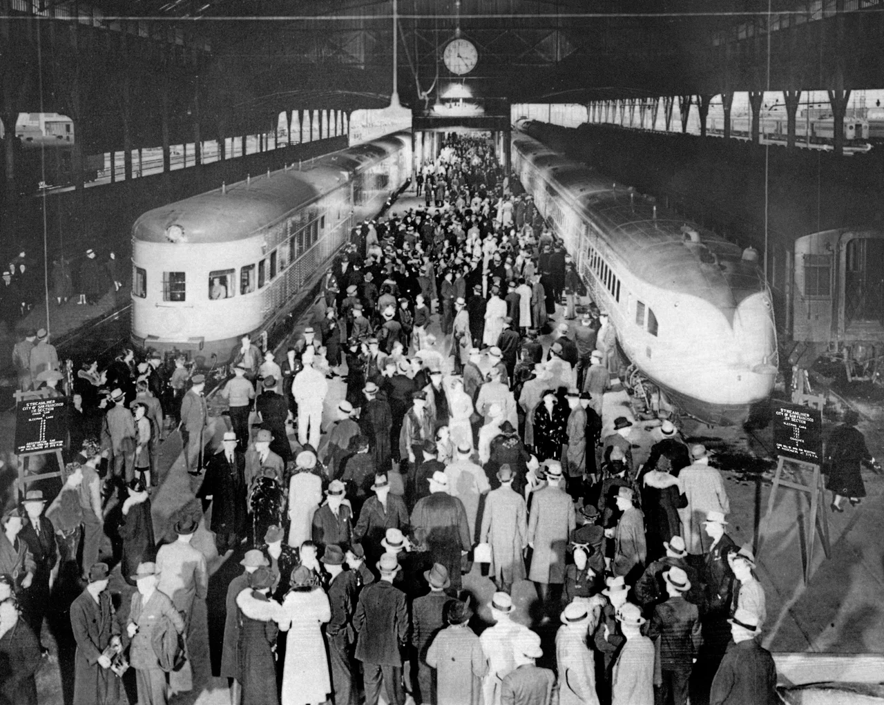 City of San Francisco joint run of original and new train sets January 2, 1938. Original caption: ""CITY OF SAN FRANCISCO" streamliner left Oakland Pier terminal in two sections on January 2, 1938, when the new ultra-modern 17-car train was inaugurated to supplant the original 11-car train which had been in operation since June 14, 1936, for the SP-UP-C&NW between San Francisco and Chicago. Both trains carried capacity loads of holiday travelers. The original streamliner was assigned to other service after this trip."