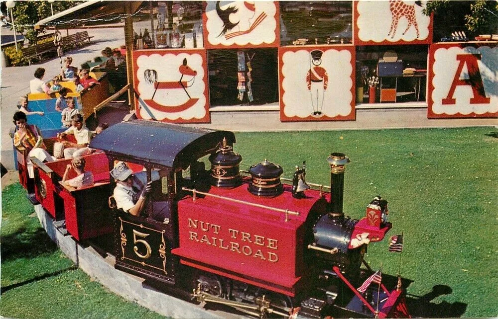 The Nut Tree Railroad train leaving the colorful Toy Shop on its way through the orchard to the Nut Tree Airport