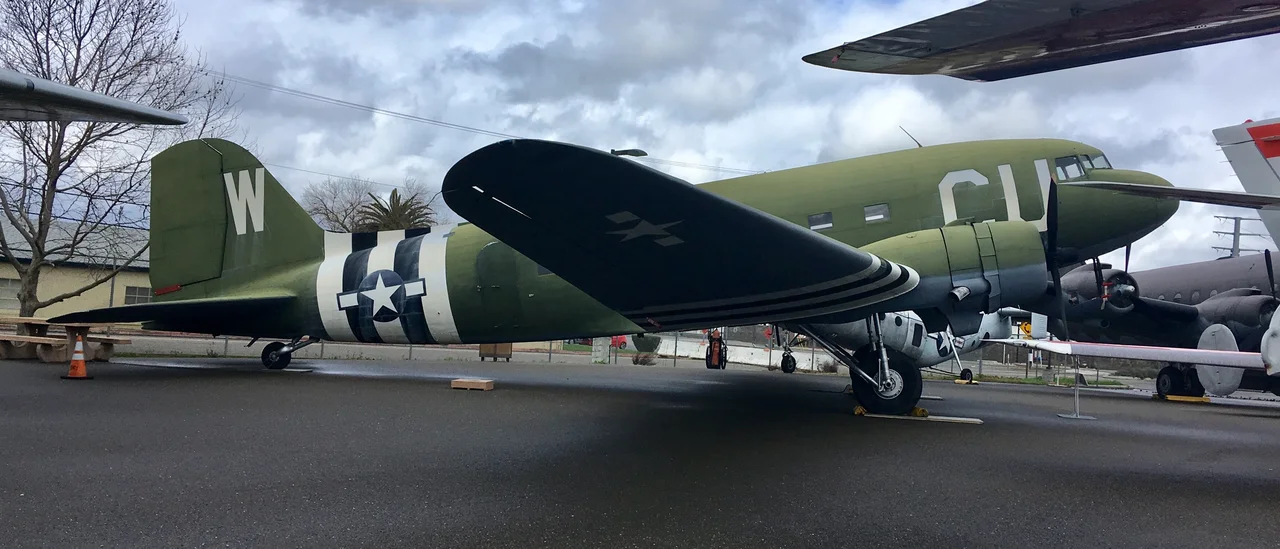 The United States Army Air Forces, the precursor to the United States Air Force, used thousands of special purpose Douglas DC-3 commercial airliners during World War II. Most common was the C-47 “Skytrain” that had a reinforced floor and large cargo door. The similar Douglas C-53 “Skytrooper” carried wounded, cargo, and paratroopers during the war.
This Skytrooper, affectionately known as “Ruby Ann” by her crew, may have flew over Normandy, France, on D-Day on June 6, 1944, doing a glider tow in the first mission of Operation Overlord. That mission started at sunrise on June 6, 1944. It did one addiditional glider tow on June 6 and one more on June 7. She also towed gliders during Operation Market Garden, the largest airborne mission in history. “Ruby Ann” likely dropped supplies to troops surrounded in Bastogne during the Battle of the Bulge, the last major German attack at the end of 1944.

After World War II, “Ruby Ann” came back to the U.S. She first flew as a passenger plane for American Airlines. She passed through several private owners before the Drug Enforcement Agency reclaimed her in July 1984. After two years of restoration, she came to rest here at the Aerospace Museum.