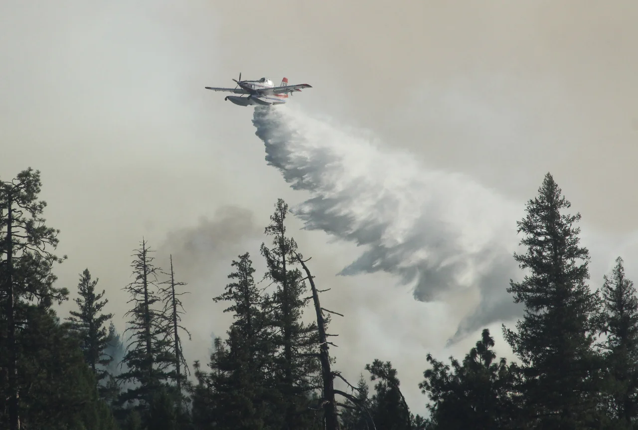Air Tractor AT802 Fire Boss drops water above State Route 36 on Rattlesnake Ridge on the August Complex North Zone. Forest Service photo by Mike McMillan