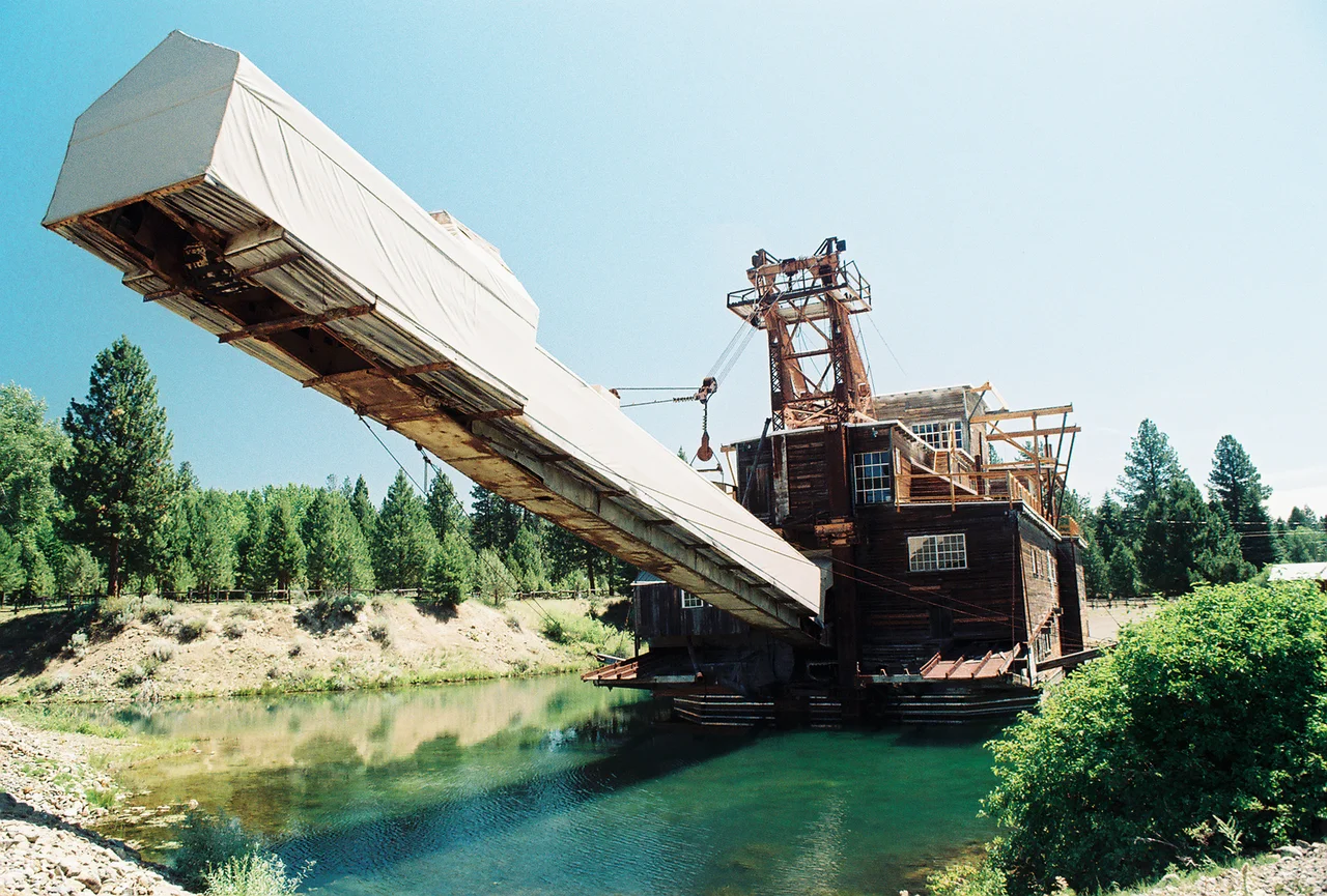 Gold Dredge in Sumpter, OR and they thought that environmental damage would fix itself. The valley that Sumpter rules over is a barren, craggy maze of tailings. THis thing went along digging up the creek bed, zig-zagging along its way and dumping rock behind it. Out of this very ramp in fact. It's been laid up in this park for a few decades now and the only life is a few scraggly trees amongst the stone. Ah, Gold fever, catch it.
