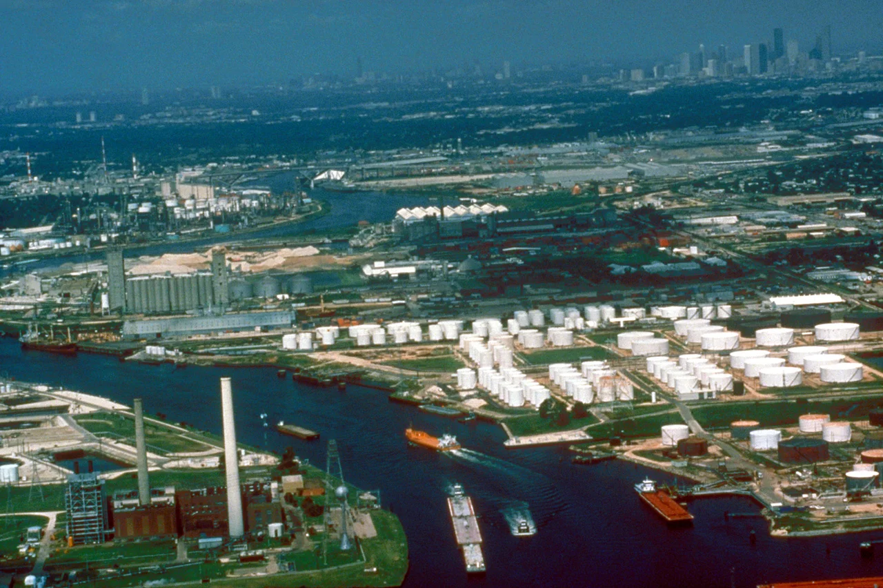 Aerial view of a small section of the Houston Ship Channel on Buffalo Bayou, which leads upstream directly into the city of Houston, Texas, USA. The downtown section of Houston can be seen at upper right. The city of Galena Park, Texas is at center right in this photograph. The U.S. Army Corps of Engineers dredges and maintains the channel for deepwater shipping. View is to the west.