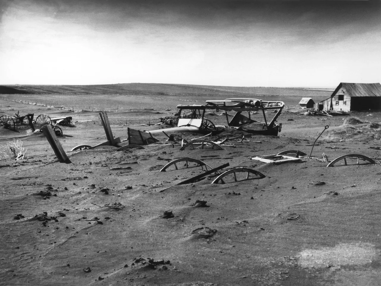 Buried machinery in barn lot in Dallas, South Dakota, United States during the Dust Bowl, an agricultural, ecological, and economic disaster in the Great Plains region of North America in 1936