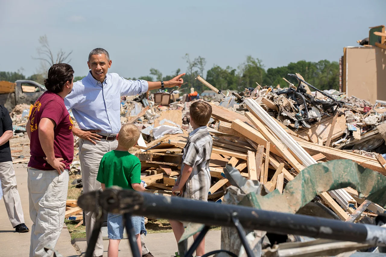 President Barack Obama talks with Daniel Smith and his sons Garrison Dority and Gabriel Dority, right, as he tours the wreckage of a tornado-damaged neighborhood in Vilonia, Ark., May 7, 2014. (Official White House Photo by Pete Souza)
