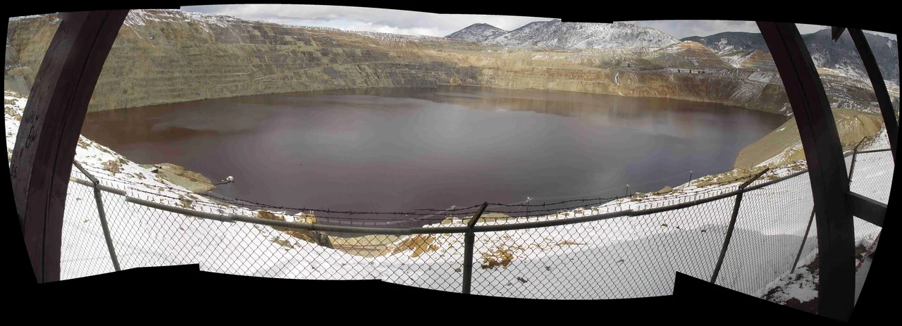 Composite fish eye view of the Berkeley Pit in Butte, Montana.  Composite was created using the open source 'Hugin' application in July, 2008, combining 7 images of the Berkeley Pit taken in April of 2005.