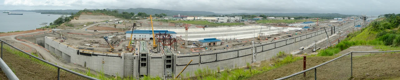 Aerial view of Gatun Locks, Panama Canal. On top, several vessels waiting to cross the locks at Gatun Lake. At the bottom is exit canal to the Atlantic Ocean. At the left of the existing locks is the construction area for the new locks part of the Panama Canal expansion project.
