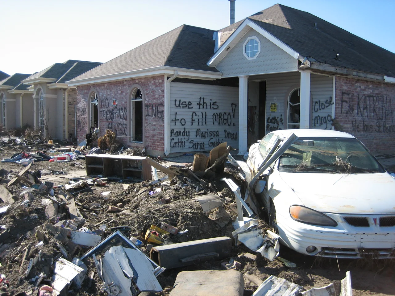 Hurricane Katrina aftermath in St. Bernard Parish, Louisiana:
House in Chalmette neighborhood devestated by storm surge from w:Mississippi River Gulf Outlet ("MRGO")  has graffiti suggesting ruins be used to fill in the "MRGO".