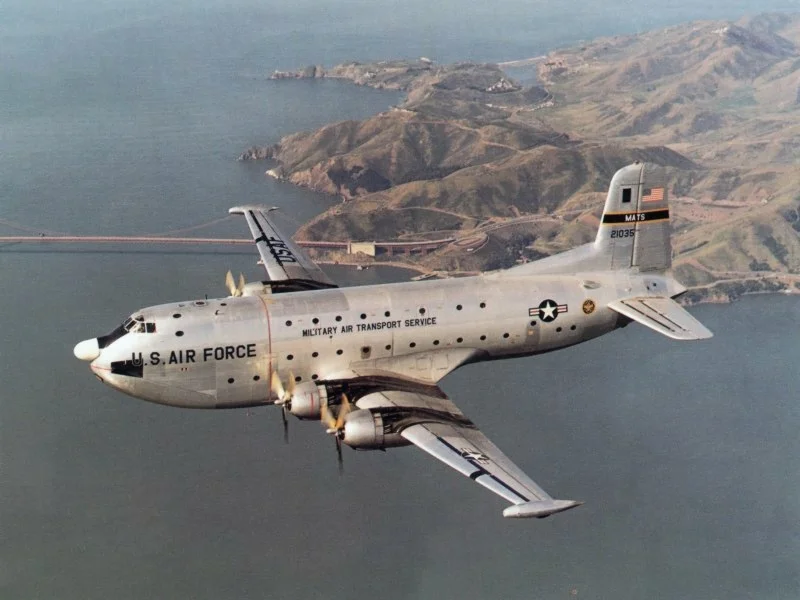 A U.S. Air Force Douglas C-124C Globemaster II (s/n 52-1035) in flight.
Golden Gate Bridge and Marin County, CA in background.

Original caption: "The Douglas C-124C Globemaster II was an airlift workhorse well into the Vietnam War."