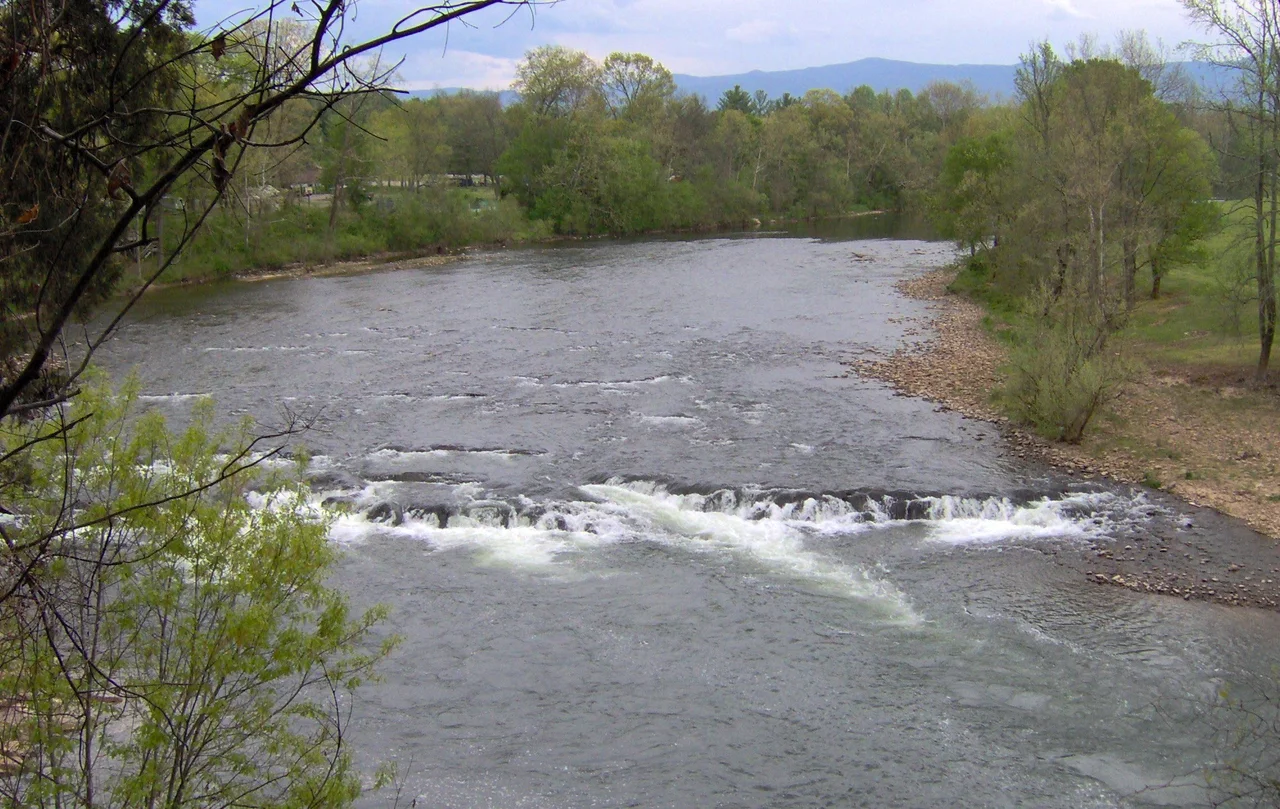 Shoals along the Nolichucky River at Davy Crockett Birthplace State Park in Greene County, Tennessee, in the southeastern United States.  Crockett recalled his brothers nearly drowning trying to paddle a canoe over a "fall" in the Nolichucky near their home.  The view is from a trail that follows the river bluffs.