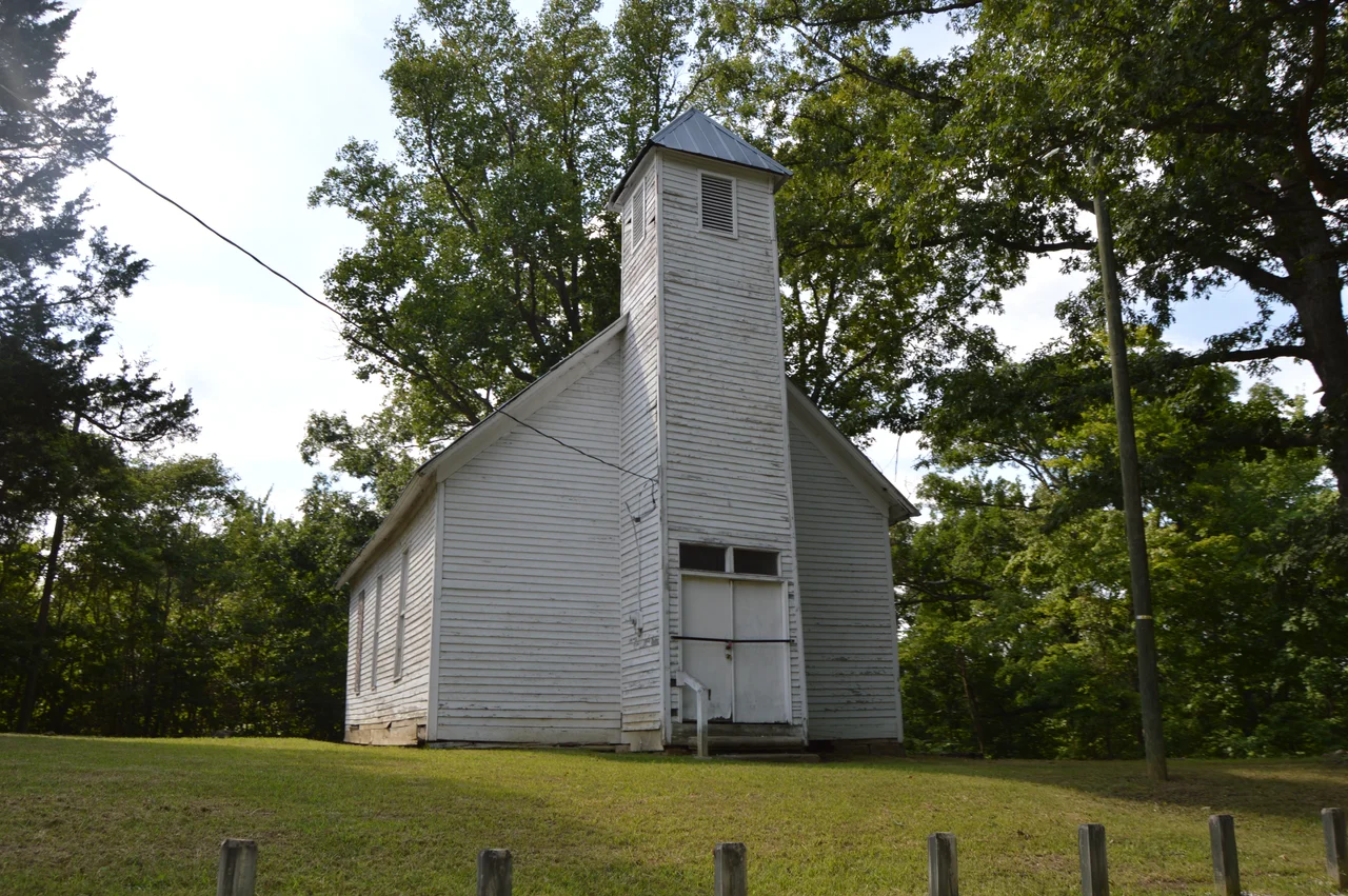 Front and southern side of the former Macedonia Church, located at the junction of Roads 120 and 144 north of Burlington in Fayette Township, Lawrence County, Ohio, United States. Built in 1849, it is listed on the National Register of Historic Places.