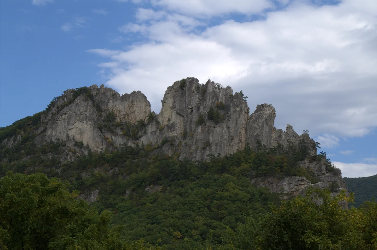 View of Seneca Rocks from the parking next to the Seneca Rocks Discovery Center in Monongahela National Forest, West Virginia, USA. A viewing platform can be seen in the upper left corner of the picture, at the edge of the rocks. The platform can be reached from the discovery center via a 1.3 mile (one way) hiking trail.
