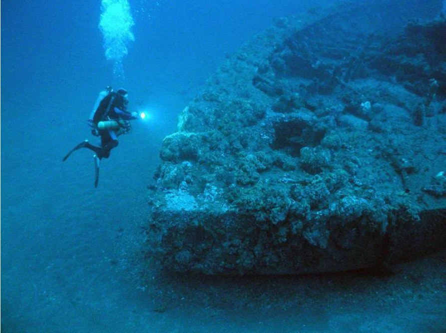 A diver examines the wreck of USS Monitor.