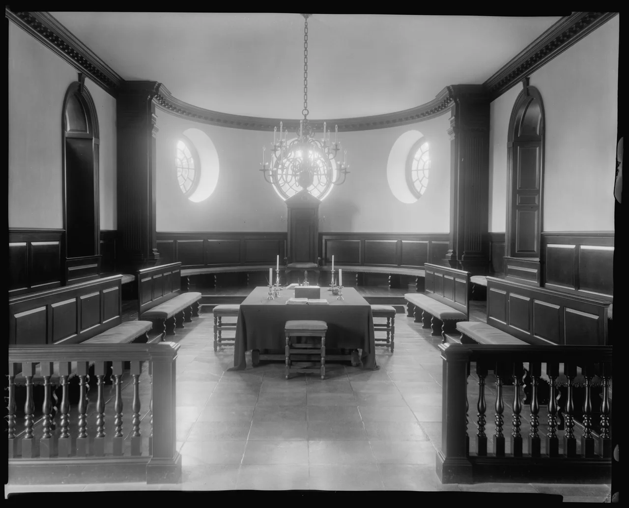 Black and white photographic view of the chamber of the House of Burgesses in the Capitol at Williamsburg, Virginia, James City County, by the American photographer and photojournalist Frances Benjamin Johnston. Dated ca. 1930-1939. From the archives of Frances Benjamin Johnston, which she donated to the Library of Congress in perpetuity, hence there are no restrictions on publication, as per the Library of Congress website. Image courtesy of the Prints and Photographs Division, Library of Congress, Washington, D.C.