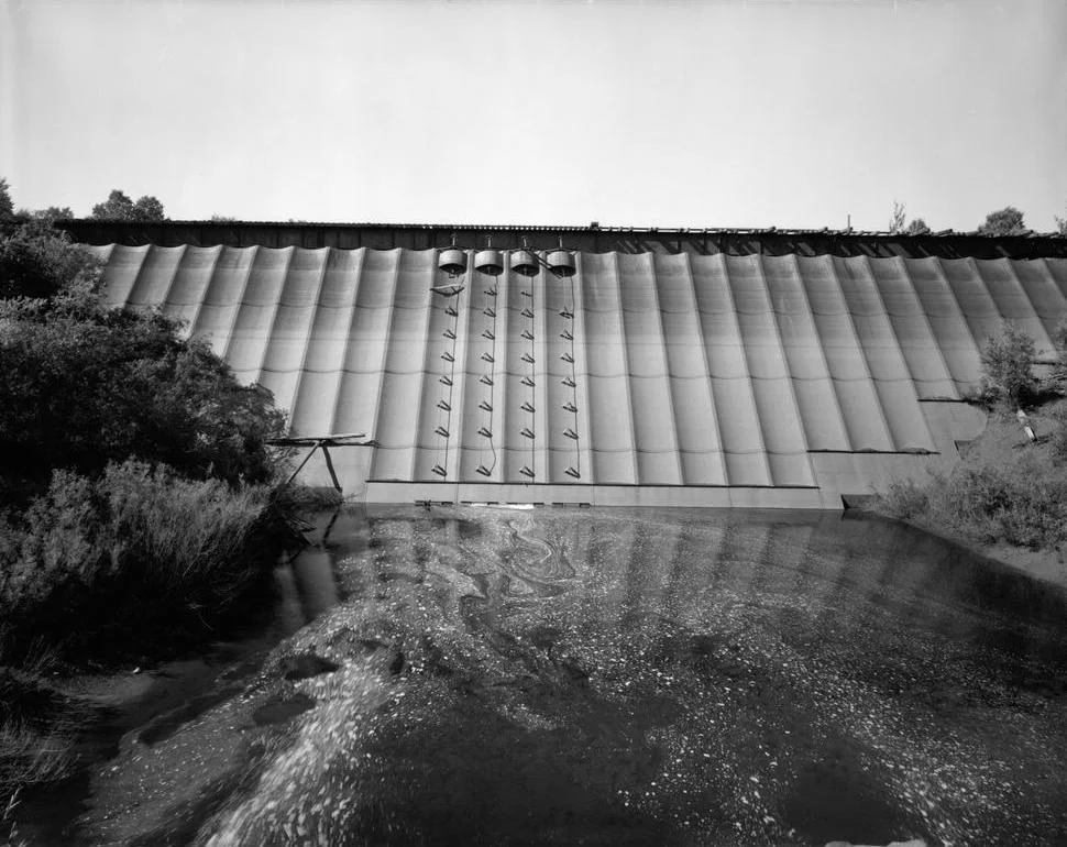 This image was found at the Library of Congress HAER archive entry with the original caption: "VIEW LOOKING AT UPSTREAM SIDE OF DAM. HAER MICH,31-BEHIL,1-1" It is a part of the Historic American Engineering Record collection of photos. Redridge Steel Dam, Houghton County, Mi, image taken by Jet Lowe, HAER photographer, in July 1978.