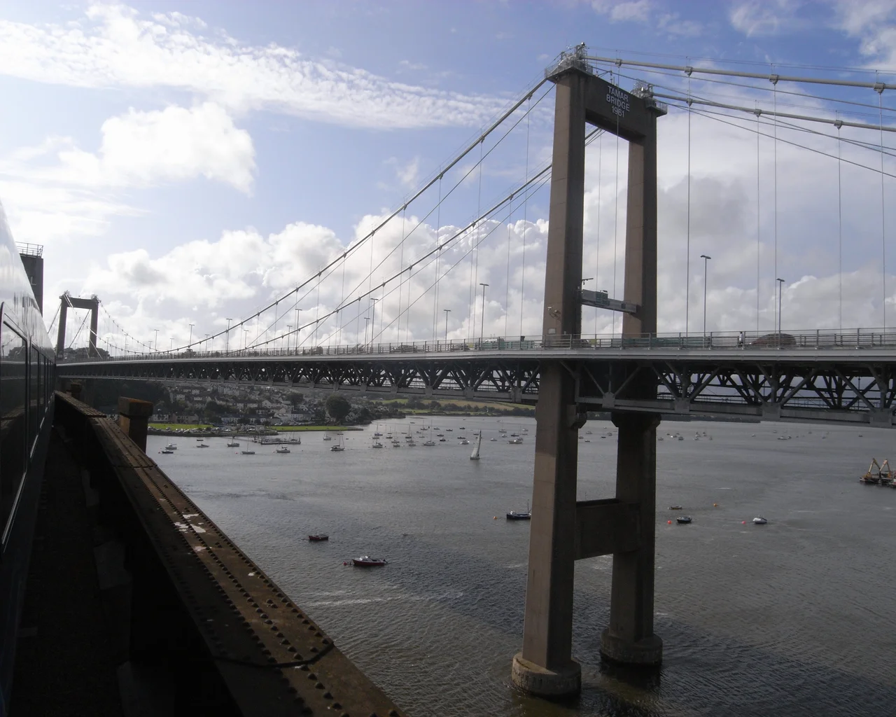 View of the Tamar Bridge taken from a train passing over the neighbouring Royal Albert Bridge, on a sunny July afternoon.