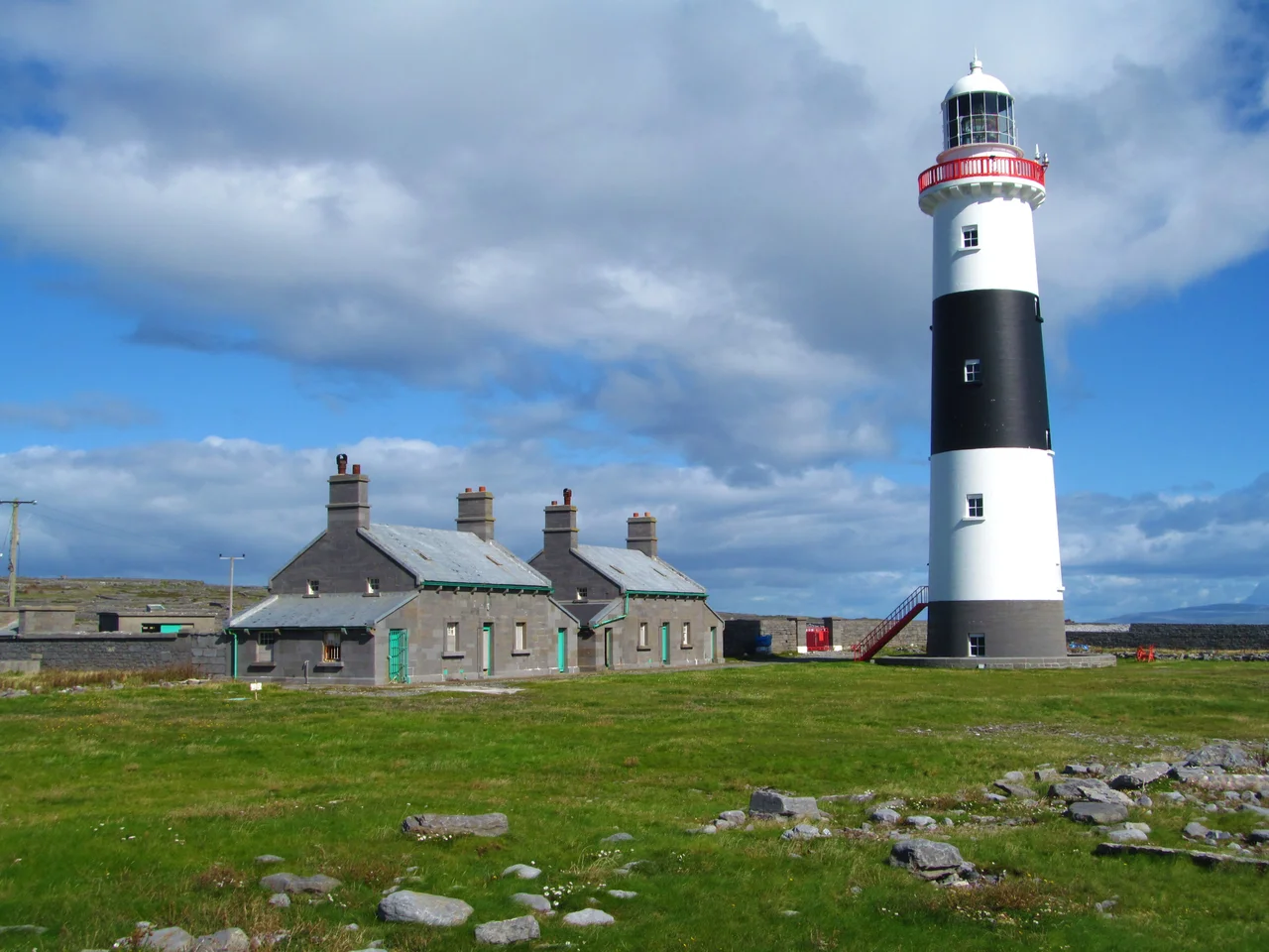Inis Oirr lighthouse. The 34m tall lighthouse was constructed in 1857 and stands at the southernmost point of the island. It is now automatic, so the cottages stand unused.