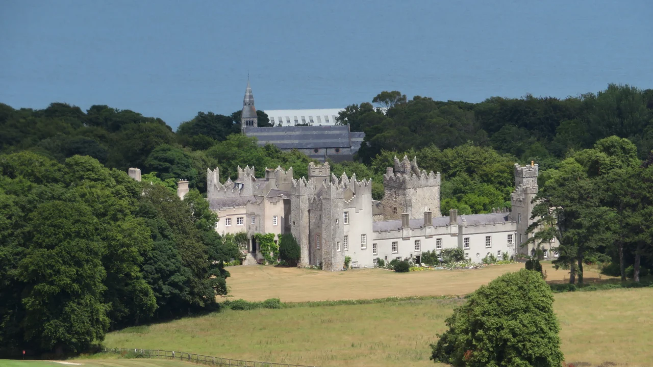 Howth Castle in Dublin, Ireland viewed from a rocky outcrop on Howth Hill. The ground appears tawnier than usual because of drought.