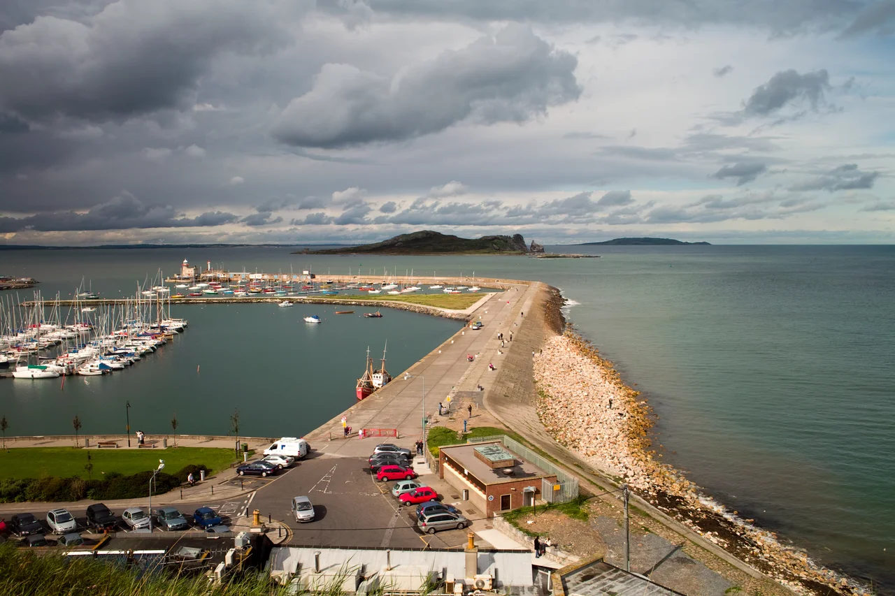 Howth Harbour is a fishing and yachting port, and popular suburban resort on the north side of Howth Head, 15km (9½ miles north-east of the Dublin city centre, Ireland. Ireland's Eye is the name of the island in the middle of the photograph.