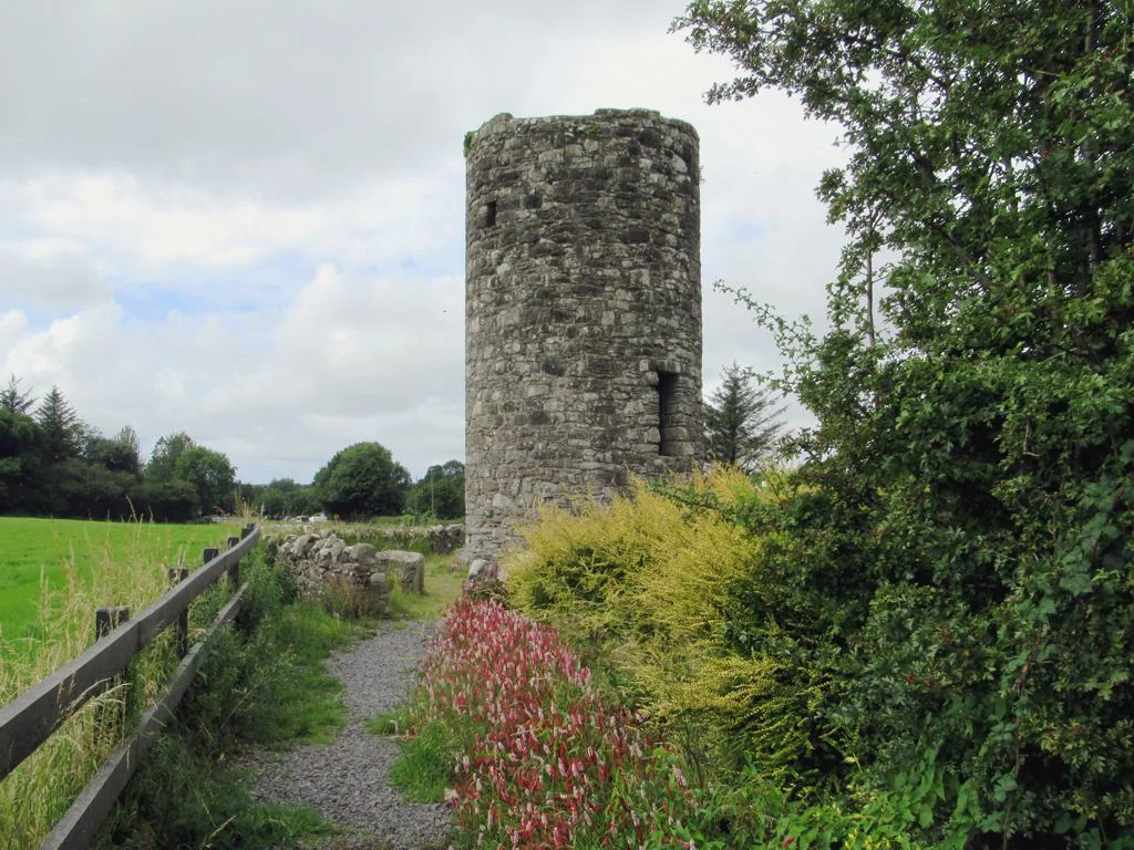 The 10th century Round Tower at Drumcliffe, County Sligo, Ireland, was once the bell tower of a monastery founded by St. Colmcille.