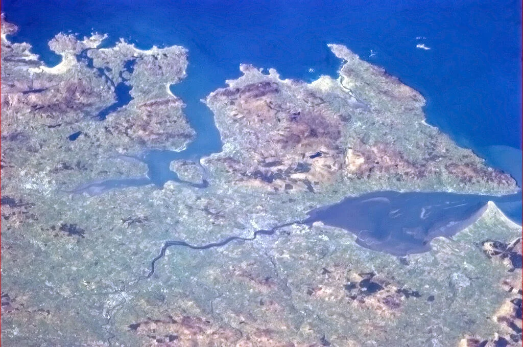 "Derry, Northern Ireland, and the rugged coast facing the North Atlantic." – Caption by astronaut Chris Hadfield on board the International Space Station.
This is one of a set of eight pictures of Ireland taken from earth orbit that were posted on the internet by Hadfield to celebrate Saint Patrick's Day in 2013.

The Inishowen Peninsula on the north coast of Ireland stands out clearly in this picture, surrounded by Lough Swilly (left) and Lough Foyle (right). The dark River Foyle winds through the countryside and empties into Lough Foyle at the city of Derry.