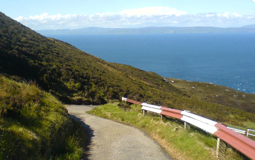 Antrim Coast from Mull of Kintyre on a sunny day, taken at an angle. Scotland (Foreground), Straits of Moyle (Mid-Ground), Northern Ireland's Antrim Coast (in distance).