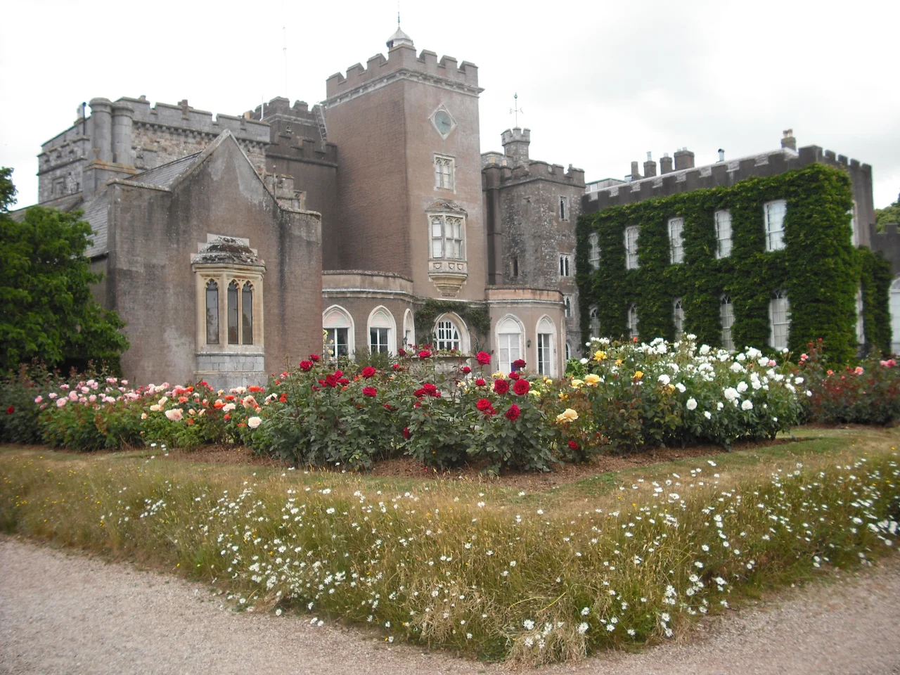 Powderham Castle from the Rose Garden, southeast in Devon, England.