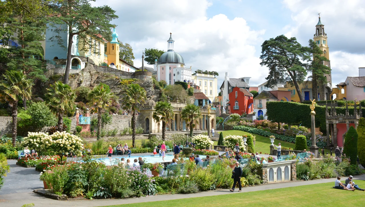 This hotel and tourist attraction in north Wales was catapulted into fame by the 1960's cult TV series "The prisoner" starring Patrick McGoohan.
From Wikipedia:
The village of Portmeirion has been a source of inspiration for writers and television producers. Noël Coward wrote Blithe Spirit while staying there. George Bernard Shaw and H. G. Wells were also early visitors. In 1956 the village was visited by architect Frank Lloyd Wright, and other famous visitors have included Gregory Peck, Ingrid Bergman and Paul McCartney.
The village has many connections to the Beatles too. Their manager, Brian Epstein was a frequent visitor and George Harrison spent his 50th birthday in the village in 1993. It was while Harrison was in Portmeirion that he filmed interviews for The Beatles Anthology documentary.
