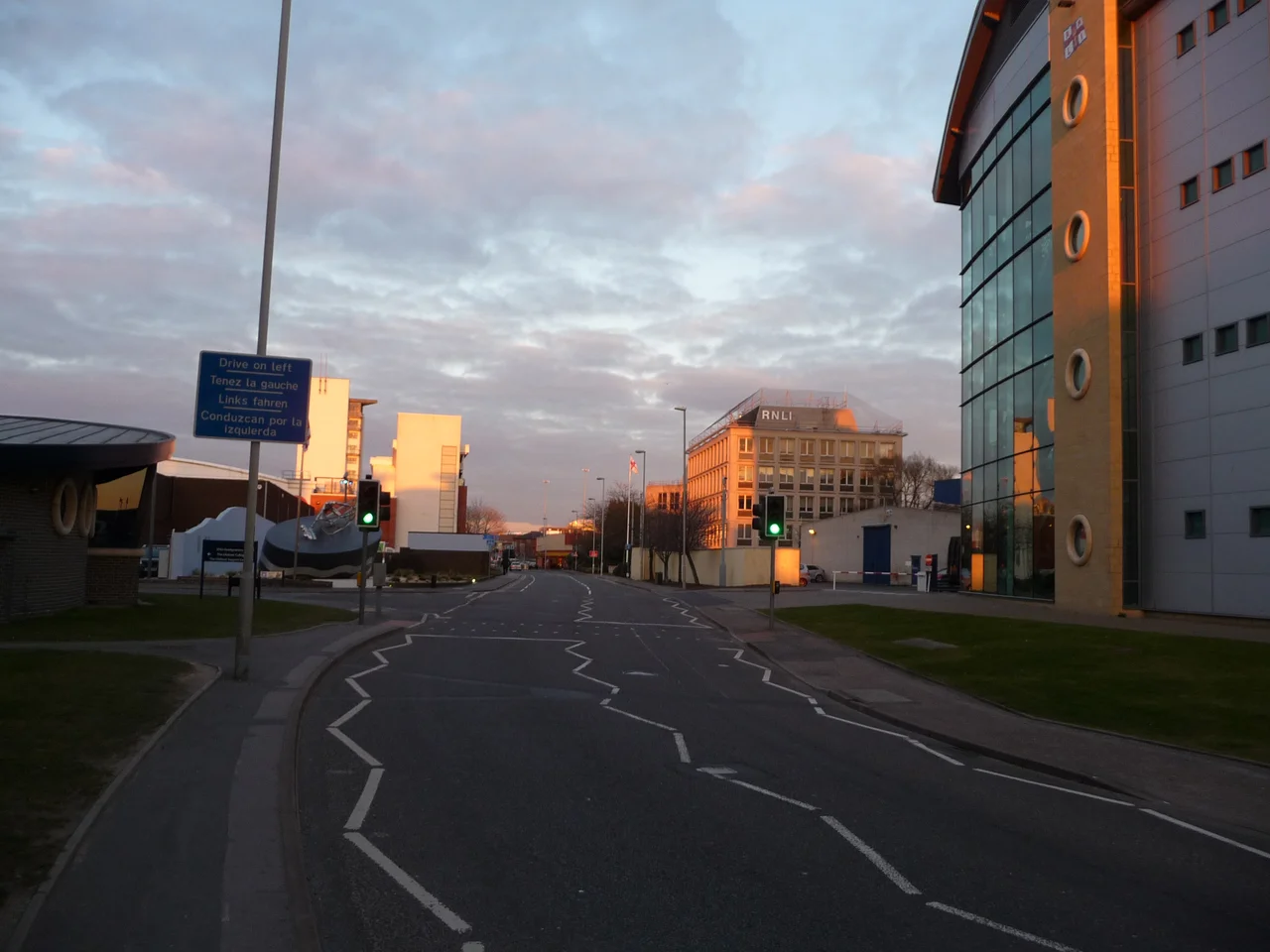 Poole : West Quay Road West Quay Road with several RNLI buildings surrounding it, and a sign which reminds us to drive on the left side of the road.
