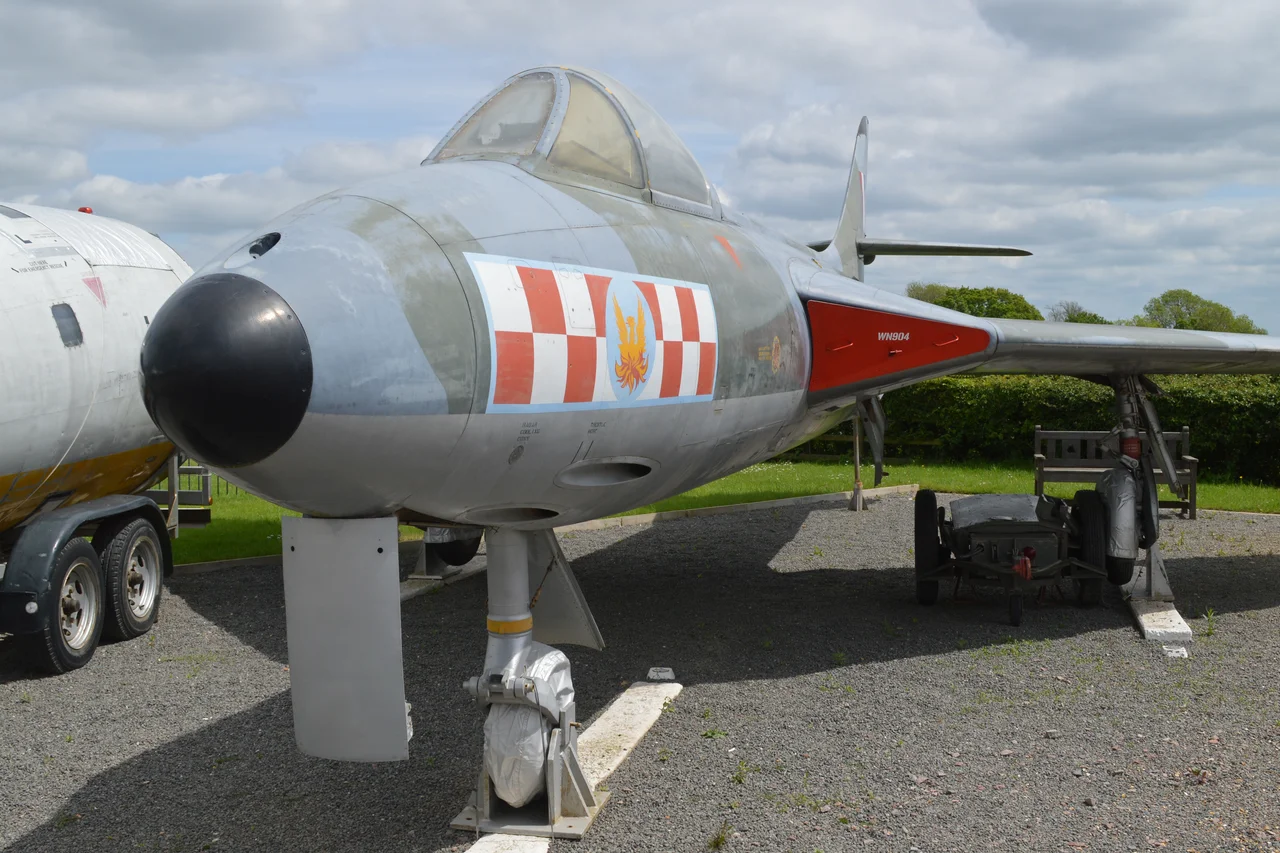 c/n S4/U/2912.
Built 1954.
British military serial WN904.
Among the 1,972 Hunters built, the F.2 was a rare mark. It was powered, along with the F.5, by the 8,300lbf Armstrong Siddeley Sapphire 101, instead of the Rolls-Royce Avon used in all other marks of Hunter.
Built by Armstrong Whitworth at Coventry, only 45 were produced and this is now the only surviving example.
Delivered to 257sqn at Wattisham in September 1954, she remained with the unit until severely damaged in January 1956. Although repaired, she was then stored until 1958 when she went to the Melksham School of Technical Training as ‘7544M’.
In 1974 she was donated to the Imperial War Museum collection at Duxford, but was later loaned out to serve as a gate guard at Waterbeach Barracks, the former RAF Waterbeach.
She is now painted in 56sqn markings and is on permanent display at the Sywell Aviation Museum.
Sywell Aerodrome, Northamptonshire, UK.
21st May 2017