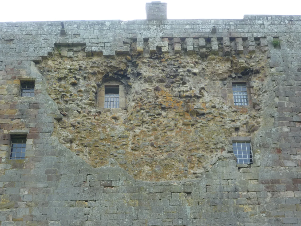 Damage believed to have been caused by a blast of artillery-fire from the guns of Oliver Cromwell in 1650. The owner, John, 10th Lord Borthwick, a supporter of the Stuarts, surrendered before the castle suffered further damage.
"To the Governor of Borthwick Castle there. Sir, I thought fitt to send this trumpet to you to lett you know, that, if you please to walk away with your company, and deliver the house to such as I shall send to receive it, you shall have liberty to carry off your armes and goods and such other necessaries as you have. You have harboured such parties in your house as have basely unhumanely murdered our men; if you necessitate me to bend my cannon against you, you must expect what I doubt you will not be pleased with. I expect your present answer, and rest your servant, O. Cromwell"