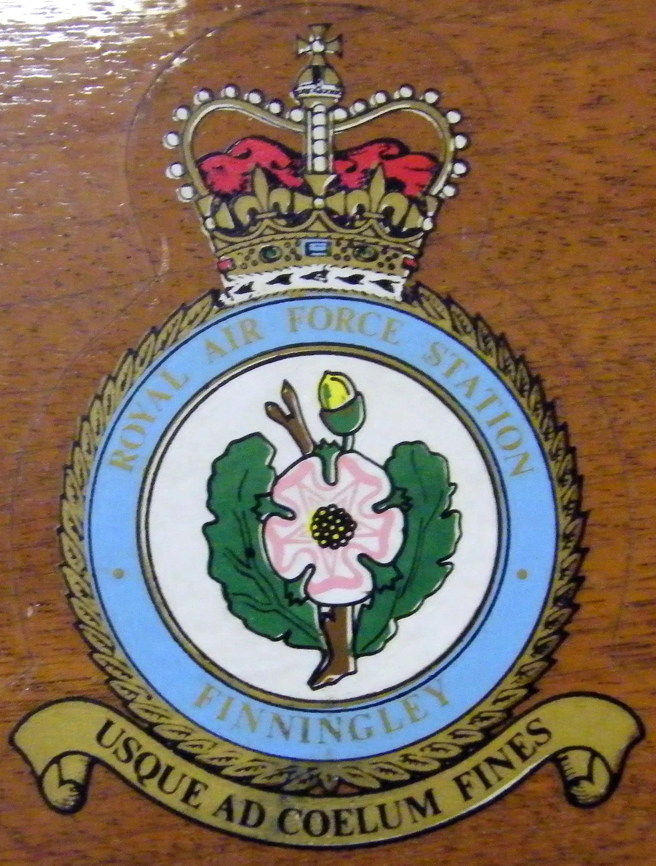 A photograph of the RAF Finningley crest, belonging to a former Royal Air Force base near Doncaster, South Yorkshire. The crest shows the White Rose and Acorn signifying the close geographical and cross boundary links between Finningley with Nottinghamshire and South Yorkshire.