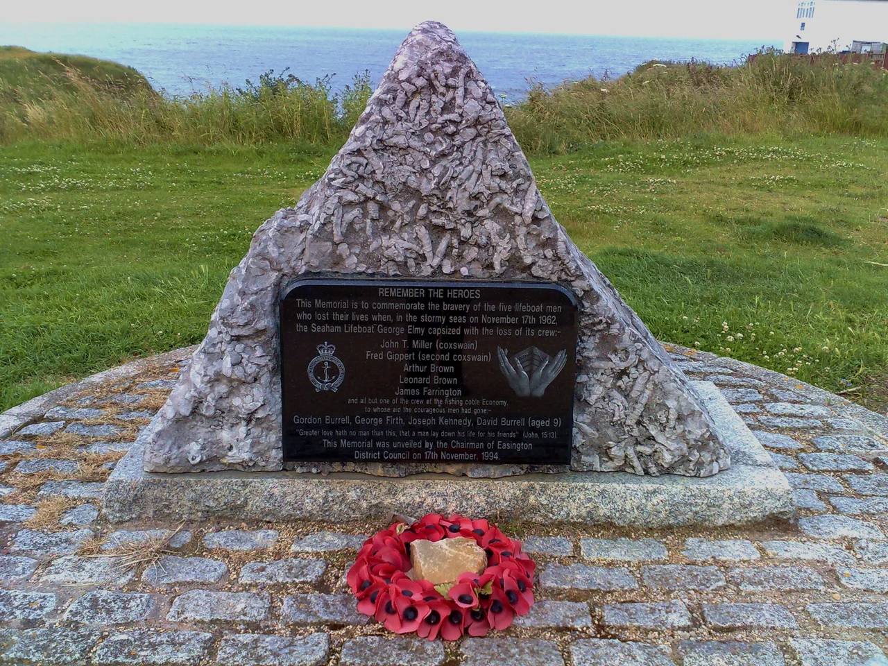01/07/2008. Seaham, North East England, on the sea front. Google Street View
This memorial is approximately 3 foot (1m) high, commemorating the eight men and one boy who lost their lives in a storm at sea over forty years ago. The inscription reads:
REMEMBER THE HEROES
This memorial is to commemorate the bravery of the five lifeboat men who lost their lives when, in the stormy seas on November 17th 1962, the Seaham Lifeboat George Elmy capsized with the loss of its crew:
John T Miller (coxswain)
Fred Gippert (second coxswain)
Arthur Brown
Leonard Brown
James Farrington
and all but one of the crew of the fishing coble Economy, to whose aid the courageous men had gone:
Gordon Burrell, George Firth, Joseph Kennedy, David Burrell (aged 9)
"Greater love hath no man than this, that a man lay down his life for his friends" (John, 15:13).
This memorial was unveiled by the Chairman of Easington District Council on 17th December, 1994.
More information is available on the official website.
UPDATE (May 09): Also this recent article in the Sunderland Echo - the George Elmy has come home to Seaham! See David John Harris' photograph of her just after she arrived.
UPDATE: (Jan 10): Restoration of the George Elmy is under way.
Once completed, she will be allowed to complete the journey she started so many years ago; sailing into the harbour one last time, before taking pride of place as the main exhibit in the newly refurbished North Dock.