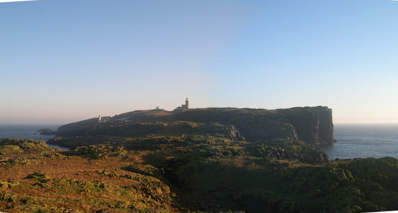 The Isle of May in the Firth of Forth, as seen from the fog horn at the northern end of the island. The Main Light can be seen on the right, the top of the original (though now much reduced in height) coal fired becon is visible in the centre and the low light is on the left. In the foreground the original compressed air pipe that run the length of the island can be seen to the left side of the picture (in line with the low light).