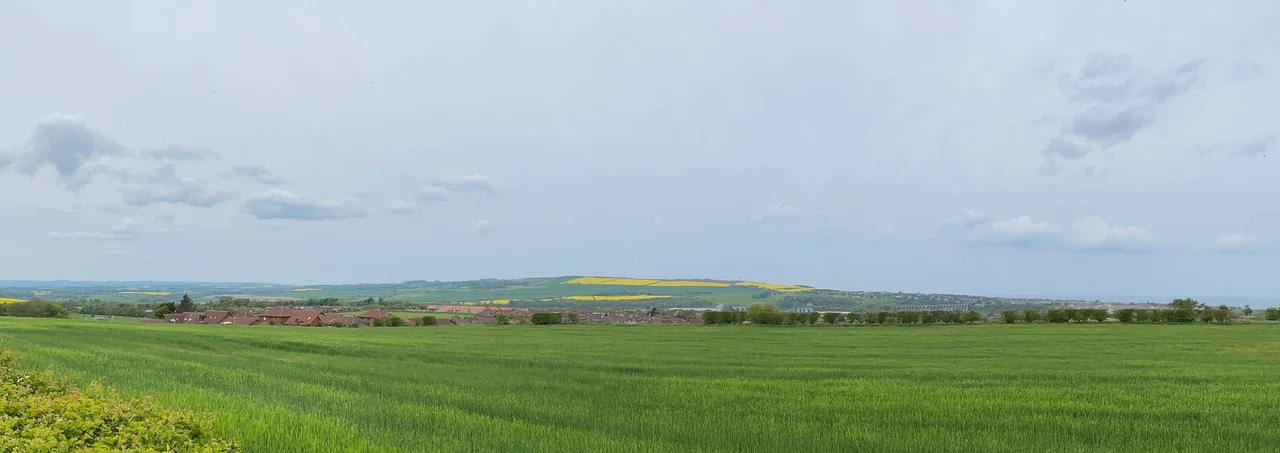 Panoramic photograph of Halidon Hill in Berwickshire. The Merse is to left of the picture, the town of Berwick Upon Tweed is to the right with the North Sea on the far right. The Royal Border Bridge is visible in front of Berwick.
