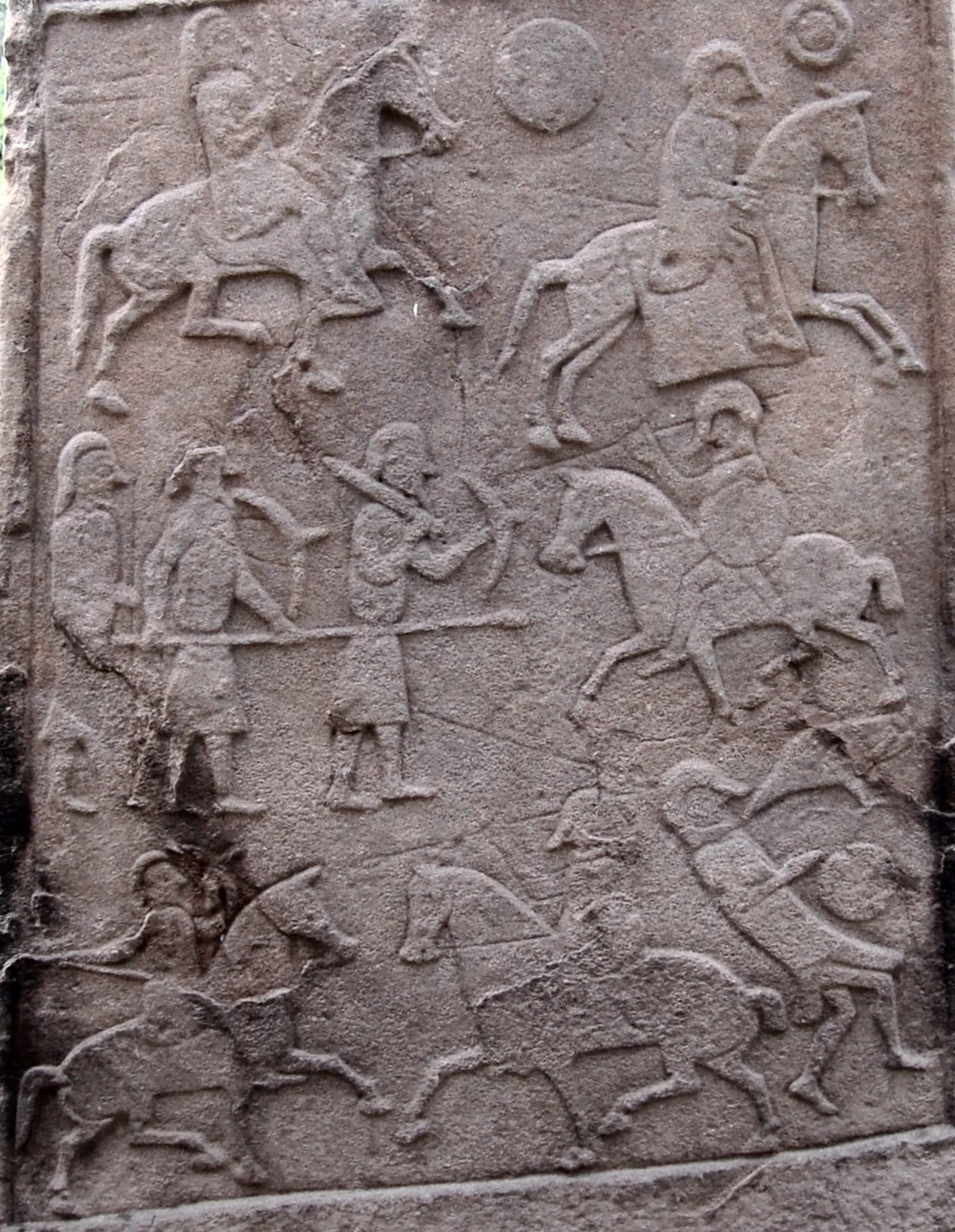 This image is a crop of a photograph of the Pictish stone in the churchyard at Aberlemno Parish Church (the stone is sometimes known as Aberlemno II).  The battle scene depicted is generally accepted to be that of the Battle of Nechtansmere.