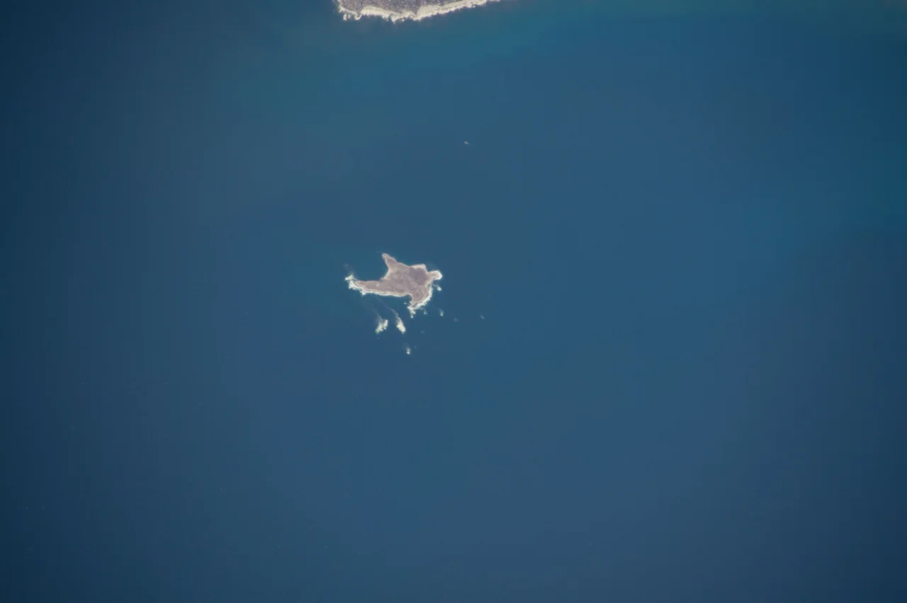 Dassen Island and lighthouse, 9 km off the coast of Yzerfontein. Lighthouse is 28 m, circular iron tower with white and red bands. 1893