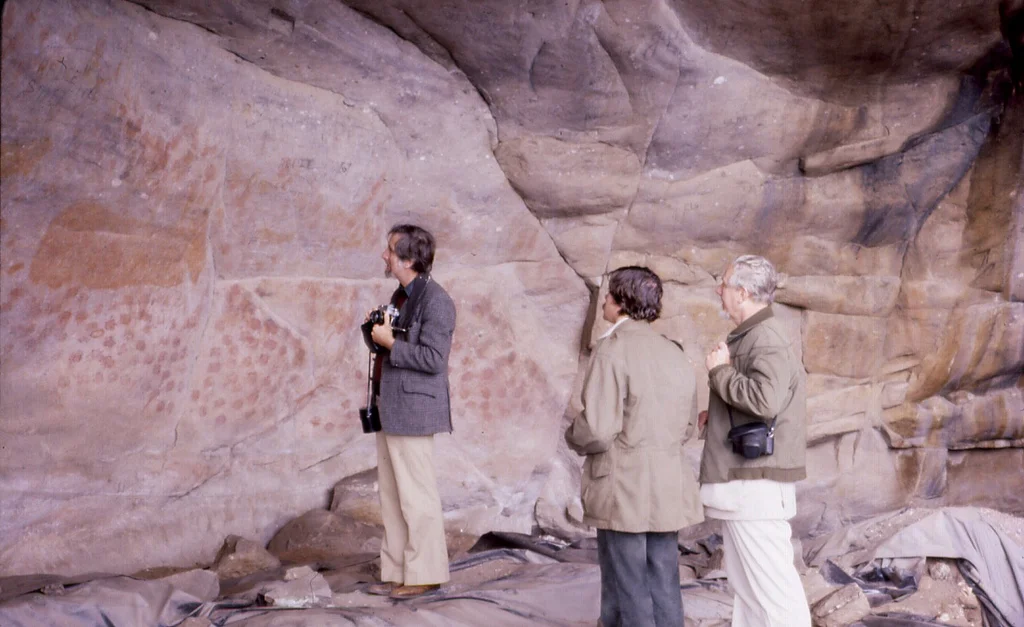 Rock paintings at Eland's Bay Cave, South Africa

Photo taken in 1979. From left to right, Merrick Posnansky, John Parkington and J. Desmond Clark.