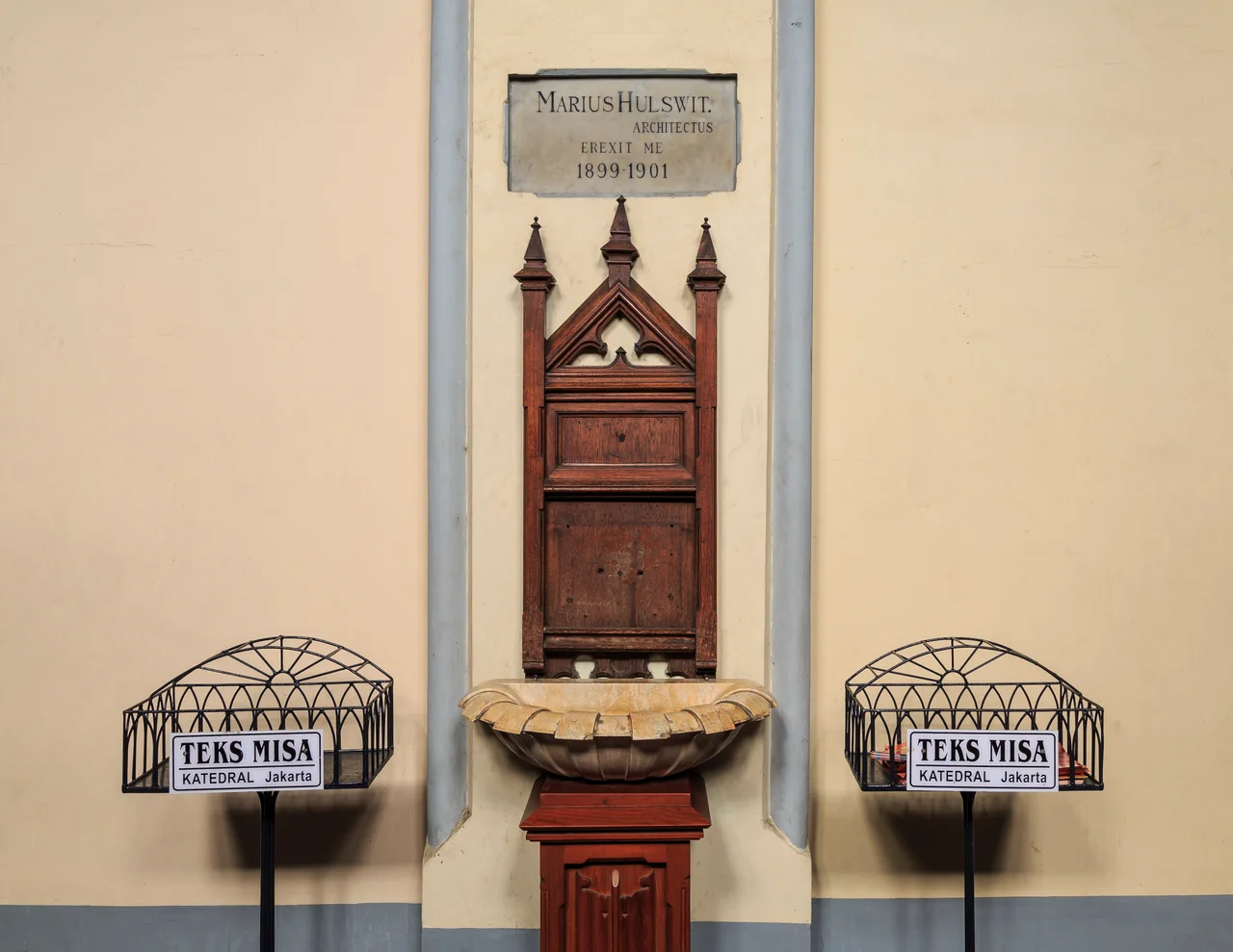 Jakarta, Indonesia: Stoup at the main entrance of Jakarta Cathedral with a memorial stone to Marius Hulswit, the dutch architect which finalized the cathedral in the years 1899 to 1901.