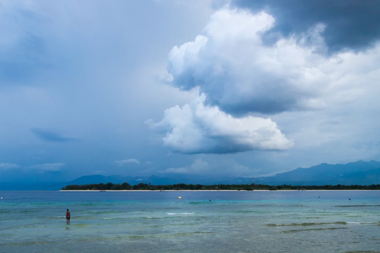Calm equatorial tropical thunderstorm clouds over the Lombok Strait, Gili Islands, Sunda Islands, West Nusa Tenggara, Indonesia in the intertropical convergence zone (ITCZ). The area can be roughly considered a divide between the Indian and Pacific Oceans.