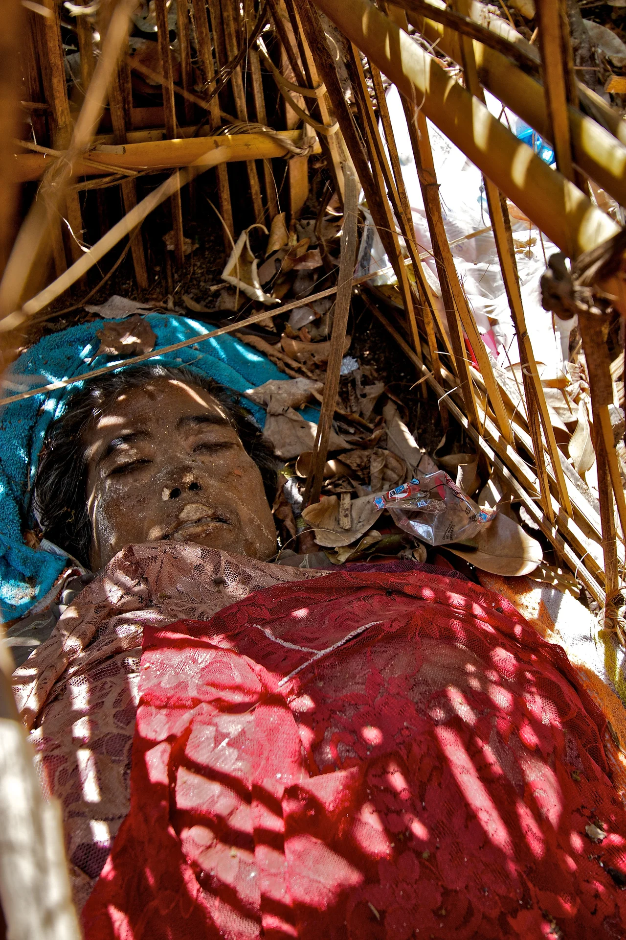 The body of a young lady, put to rest a month ago to decompose, Trunyan, Lake Batur, Bali, Indonesia