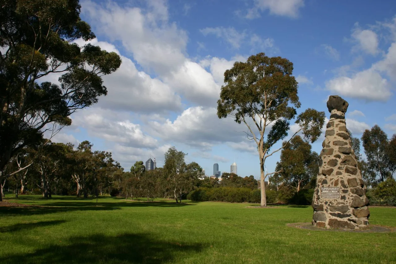 The Burke and Wills expedition monument in Royal Park with the city skyline in the background.
