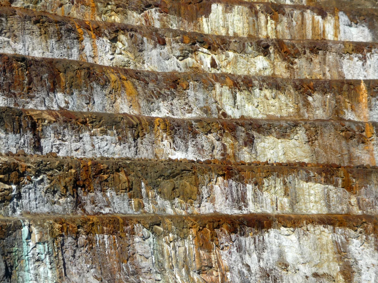 Photo of Mary Kathleen Mine close-up.  Two people can be seen on the second terrace (from the bottom of the image) to the right of the image.