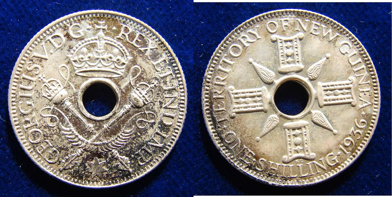 5.4 g Sterling Silver
George V, 1921- 1936
Hole in centre, flanked by crossed sceptres and crownabove Around: "* GEORGIUS V. D G REX ET IND. IMP. *"/ On the reverse the hole is flanked by indigenous designs, around: "TERRITORY OF NEW GUINEA ONE SHILLING date". KM 5
Medallist: KG (George Kruger Gray), 1880 London - 1943 Chichester, England.


Condition: Nicely toned EXTREMELY FINE.