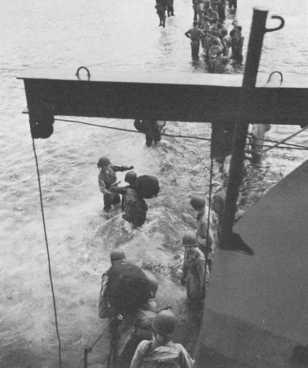 American troops disembarking from a LCI in their way to Kiriwina Island during Operation Chronicle.
