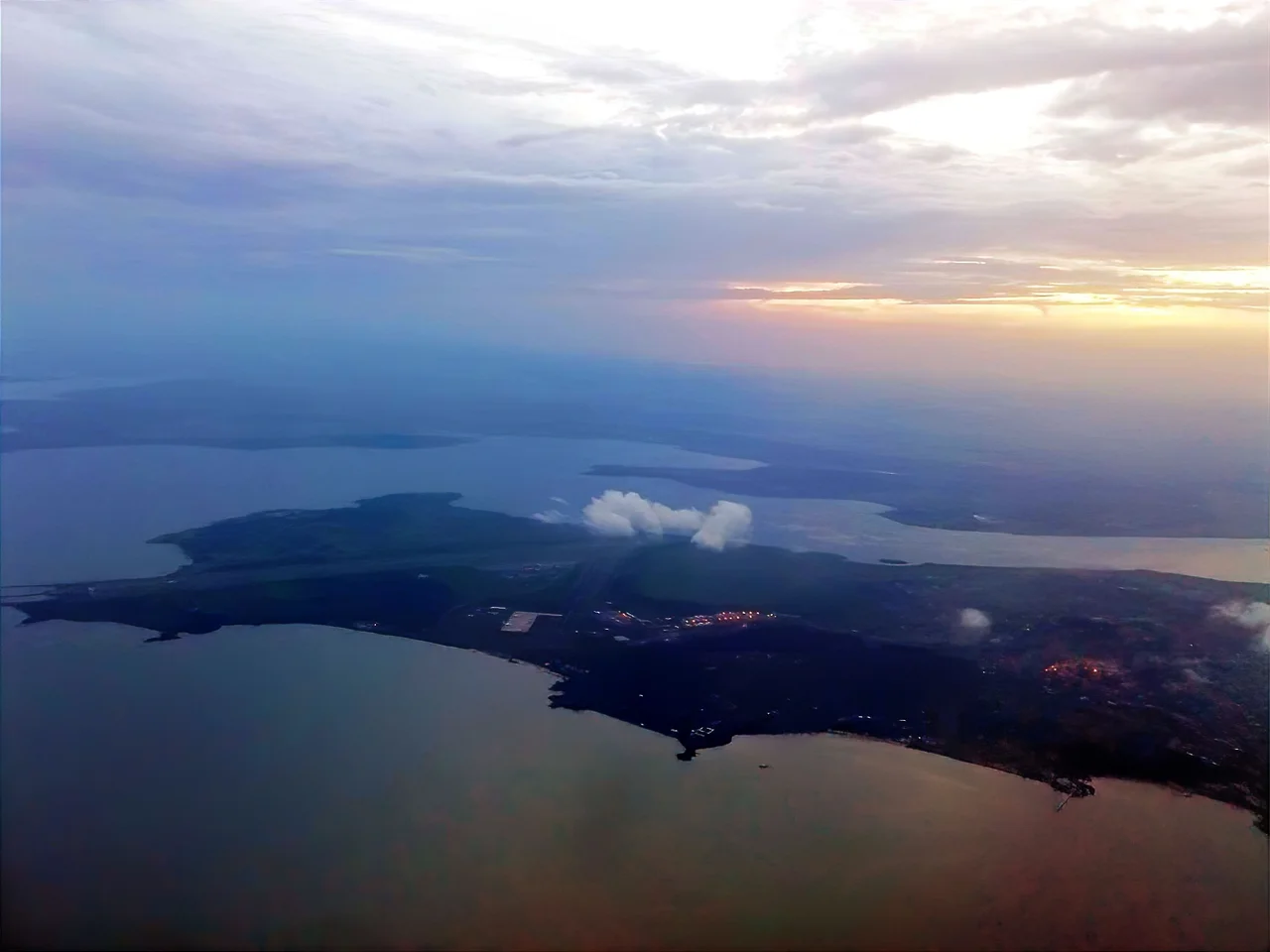 Aerial shot of the city of Entebbe and Entebbe International Airport in sunset.