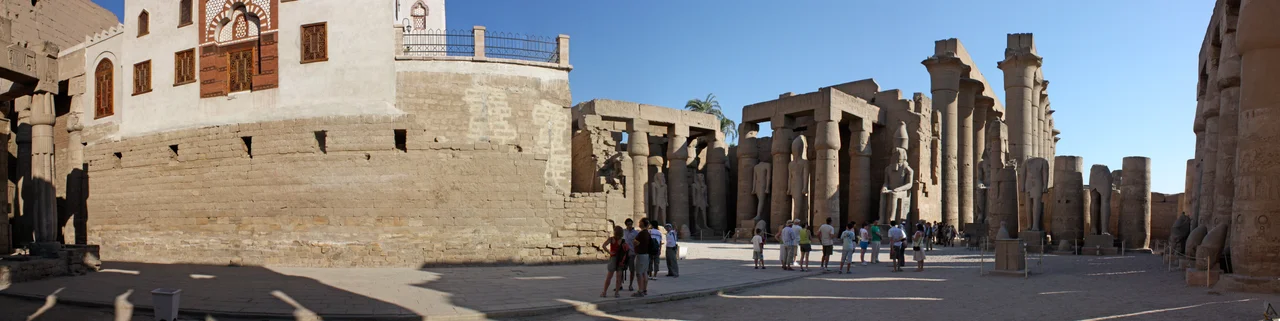 A panoramic view of the interior of the Luxor temple, just inside the entrance. The mosque built over the ruins is on the left