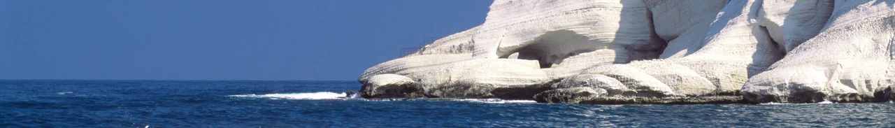 Rosh HaNikra  is a geologic formation in Israel, located on the coast of the Mediterranean Sea, in the Western Galilee. It is a white chalk cliff face which opens up into spectacular grottoes. The picture shows the cliff and the grottoes from the shore.Photo taken by Itamar Grinberg for the Israeli Ministry of Tourism. Credit attribution requested.