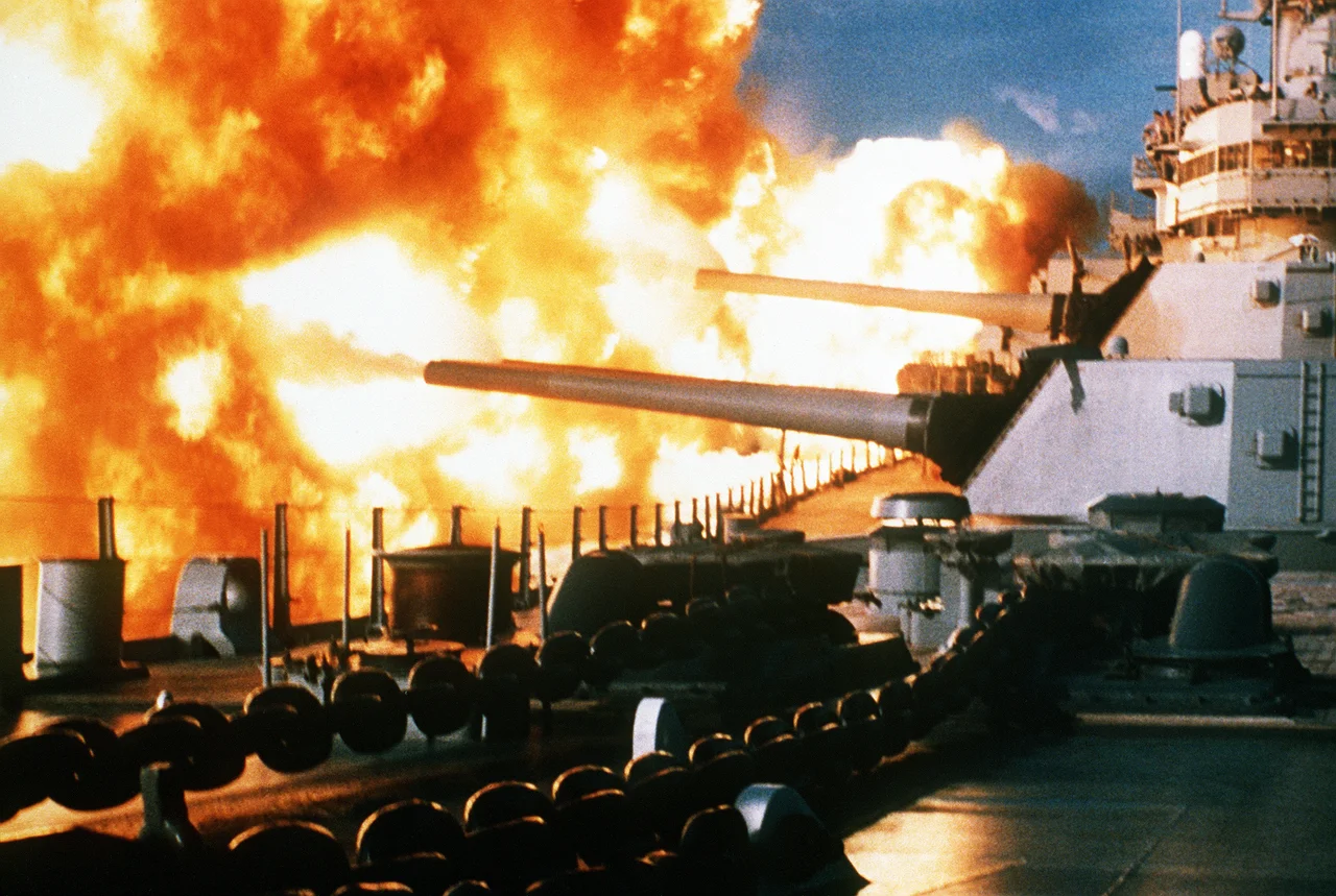 The USS New Jersey fires a salvo from its 16"/50 guns during a deployment off the coast of Beirut, Lebanon.